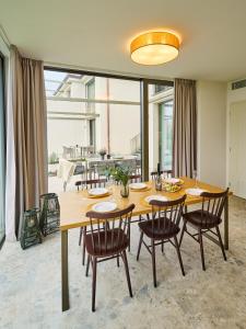 a dining room with a large wooden table and chairs at Apartment Pálava in Pasohlávky