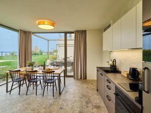 a kitchen and dining room with a table and chairs at Apartment Pálava in Pasohlávky