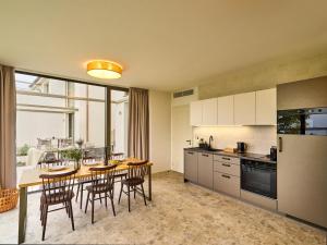 a kitchen with a wooden table and chairs in a room at Apartment Pálava in Pasohlávky +56 photos