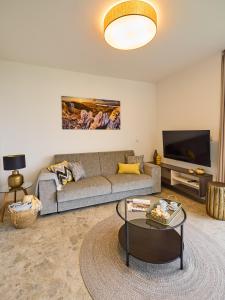 a living room with a couch and a coffee table at Apartment Pálava in Pasohlávky