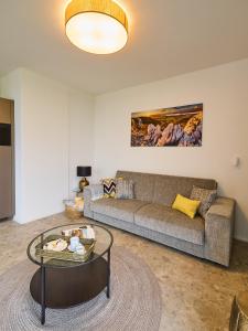 a living room with a couch and a table at Apartment Pálava in Pasohlávky