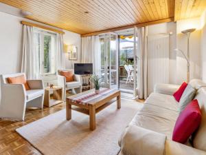 a living room with a couch and a table at Apartment Schweizerhof Apt- S by Interhome in Wengen