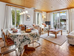 a living room with a table and a couch at Apartment Schweizerhof Apt- S by Interhome in Wengen +29 photos