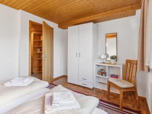 a bedroom with two beds and a mirror at Apartment Schweizerhof Apt- S by Interhome in Wengen