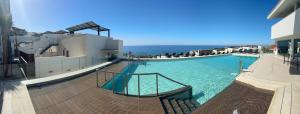 a large swimming pool with the ocean in the background at El Mirador Casa #8 in Torrox Costa