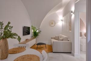 a white living room with a couch and a chair at Ancienne cave de pêcheur in La Ciotat +11 photos