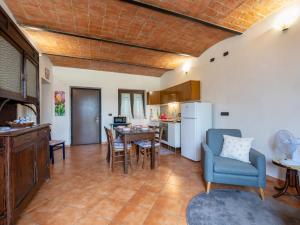 a kitchen and living room with a table and chairs at Apartment Casa dei Nonni by Interhome in Cascine di Pietra +20 photos
