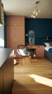 a room with a bed and a chair in it at Aozora Central Studio in Bucharest