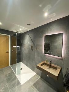 a bathroom with a sink and a shower at 3 Bed home in Lincolnshire in Wigtoft
