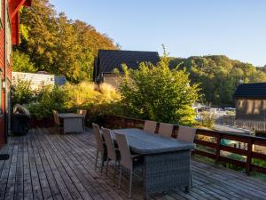a patio with a table and chairs on a deck at Holiday Home Nesjaholmen by Interhome in Kalavåg