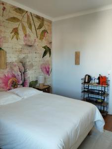 a bedroom with a white bed and a brick wall at Villa Saint-Germain in Saint-Georges-de-Didonne