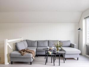 a living room with a couch and a table at Holiday Home Pale by Interhome in Bømlo