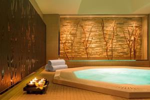 a jacuzzi tub in a bathroom with candles at The Westin Dubai Mina Seyahi Beach Resort and Waterpark in Dubai
