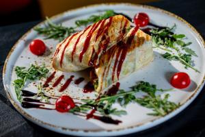 a plate with a piece of food on a table at Hotel Botanica in Belgrade