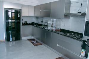 a kitchen with white cabinets and a counter top at Fully furnished apartment in Nyali near the beach in Mombasa
