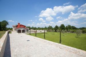 a brick walkway leading to a building in a park at Residence Monaco for 10 people in Central Istria with 65 m2 private pool, large garden & spa in Svetvinčenat