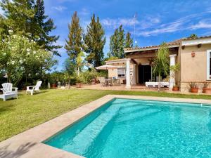 a swimming pool in the yard of a house at Villa Miranda in El Rompido