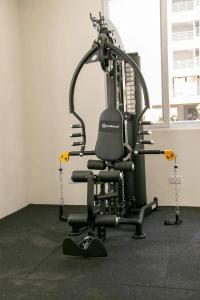 a gym with a black chair in a room at Fully furnished apartment in Nyali near the beach in Mombasa