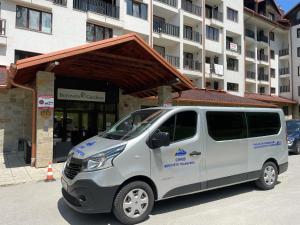 a white van parked in front of a building at large apartment in Borovets in Borovets