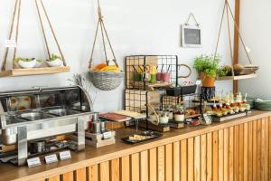 a buffet with food on top of a counter at White Mountain Apartment in Banovci +17 photos