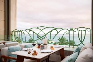 a dining room with a table and a view of the ocean at Hyatt Regency Nice Palais de la Méditerranée in Nice