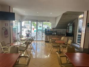 a restaurant with tables and chairs and a kitchen at Hotel Jean Marie in Arma di Taggia +34 photos