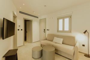 a living room with a couch and a tv at Opal Paros in Naousa