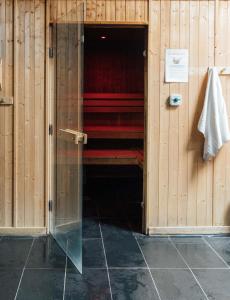 a room with wooden walls and red beds in it at Queens Hotel & Spa in Brighton & Hove