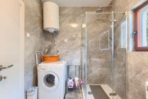 een badkamer met een wasmachine en een douche bij Casa Anka in Medulin +21 foto's