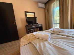 a hotel room with a bed with towels on it at Мия4 Спа хотел Свети Спас in Velingrad