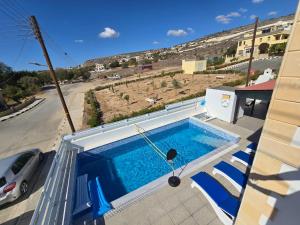 a swimming pool on the side of a house at Michael Angelo Luxuri Villa 4 bedroom in Paphos