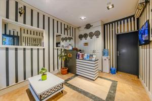 a room with striped walls and a table and a refrigerator at La Pazza Suites in Istanbul