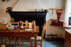 a dining room with a table and a fireplace at Albergo Casa Santo Stefano in Miglieglia