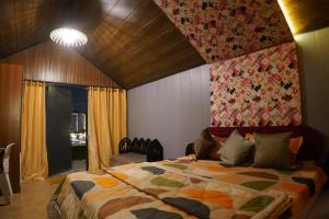 a bedroom with a large bed in a room at Great Escape Club Indore in Indore