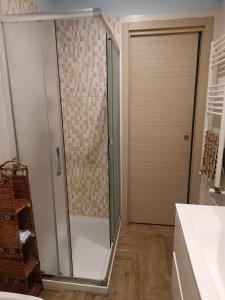 a shower with a glass door in a bathroom at Casa Azzurra in Giardini Naxos +12 photos