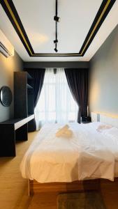 a bedroom with a large bed and a large window at Spacious Apartment near IIUM Medical Centre, ECR & Teluk Cempedak with Smart TV & Pool in Kuantan