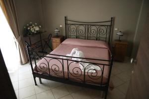 a bedroom with a bed with a white dog laying on it at Locanda Belvedere Da Stefano in Rocchetta a Volturno