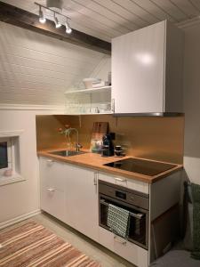 a kitchen with a sink and a stove top oven at Bellmangården in Matfors