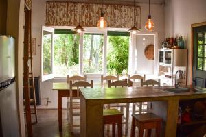 a kitchen with a table and chairs and a refrigerator at Hostel Tandil in Tandil