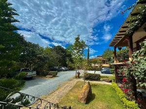 a street with cars parked on the side of the road at Hotel Casa Cantabria Campestre in Villa de Leyva