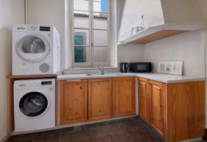 a kitchen with a washing machine and a sink at Klokkari Stays - Cozy Stay City Center By Platform 357 in Nicosia