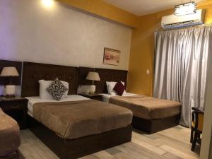 Ένα ή περισσότερα κρεβάτια σε δωμάτιο στο The location Hotel