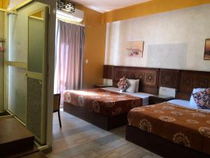 Ένα ή περισσότερα κρεβάτια σε δωμάτιο στο The location Hotel