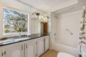 a bathroom with a sink and a tub and a window at Garten Haus in Jacksonville +42 photos