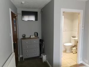 a bathroom with a sink and a toilet in a room at Kings Head in Berwick-Upon-Tweed