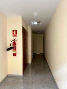 a fire extinguisher on the wall of a hallway at Detail Tacoronte in Tacoronte