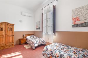 a bedroom with two beds and a dresser in it at Masa La Bomba in Premiá de Mar +36 photos