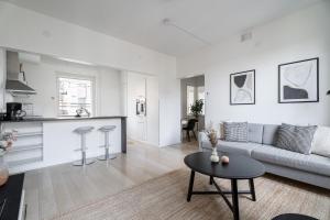 a living room with a couch and a table at 1BR Penthouse with Sauna & Rooftop Terrace in Tampere +17 photos