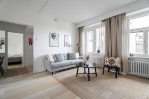 a living room with a couch and a table at 1BR Penthouse with Sauna & Rooftop Terrace in Tampere