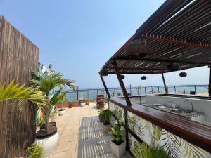 a balcony with plants and a view of the ocean at Art House in Luanda